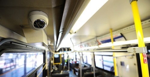 Interior of a school van showing CCTV camera surveillance for student security.