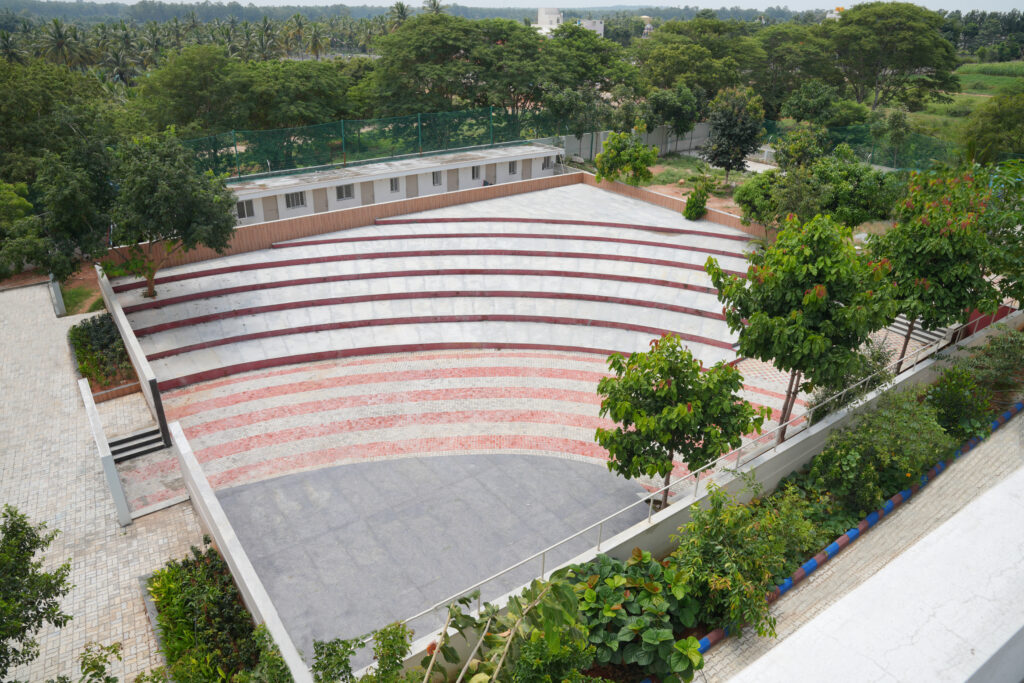 Aerial view of the open-air amphitheatre and tiered seating area at Aadya Academy Budigere campus