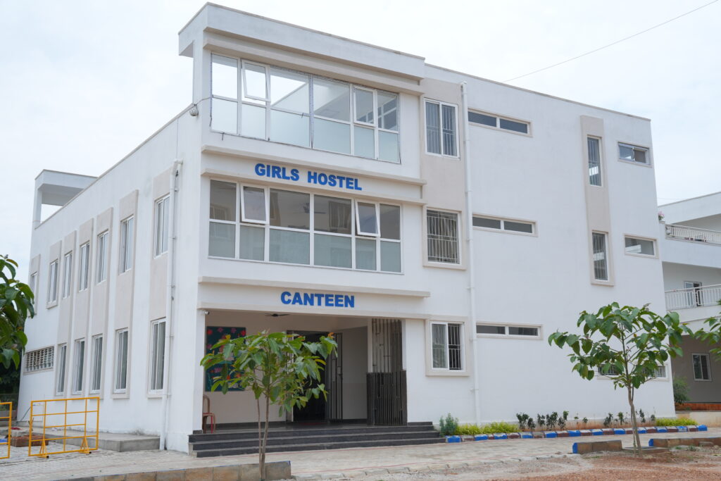Exterior view of the multi-story Girls Hostel and Canteen building at Aadya Academy Budigere campus
